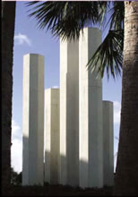 White, concrete columns near trees